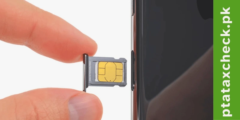 a hand holding a sim card